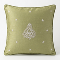 An olive green Chikankari throw pillow with a white embroidered central teardrop motif and small scattered star-like embroidery, set against a plain white background.