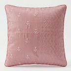 Chikankari pink throw pillow with white embroidered floral motifs and textured chevron patterns, shown against a plain white background.