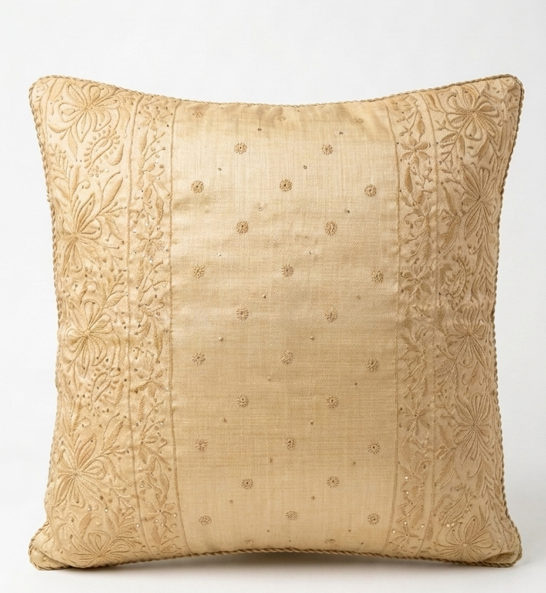 Chikankari Cushion -decorative throw pillow in a warm beige or light gold color, featuring a central panel with subtle embroidered dots and two vertical side borders with detailed floral embroidery, shown against a plain white background.